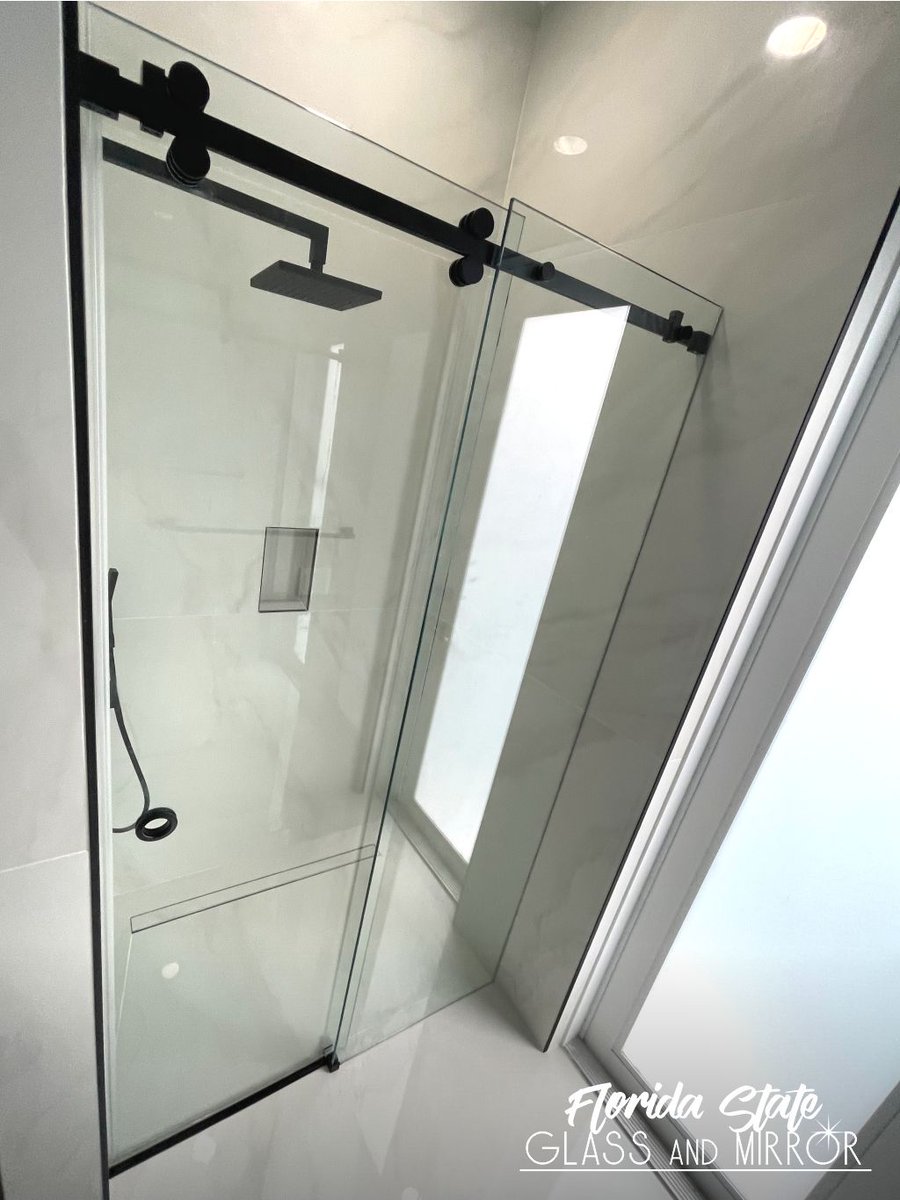 Sliding Frameless Shower Door in Matte Black with Clear Glass. Call Us for a Free Estimate at 561-997-6990 #framelessshower #framelessshowerdoor #framelessglass #blackhardware #shower #showers #showerdoors #showerenclosure #glassandmirrorexperts #glassexperts #floridastateglass