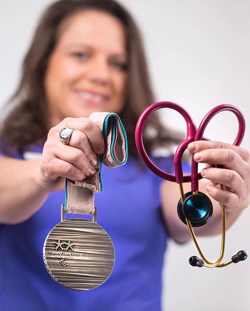 Brittani Coury holds her silver medal and her medical stethoscope 