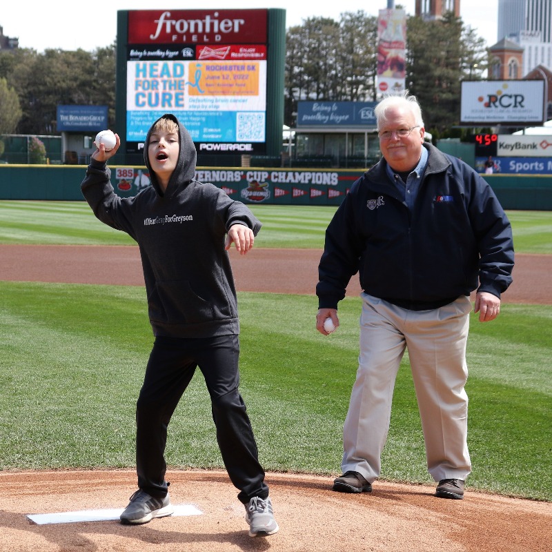 URNeuroscience's tweet photo. ICYMI: Greyson Peck, 9, threw out the 1st pitch at the @RocRedWings this weekend. He was on the mound w/ @UR_Med Dr. Web Pilcher to kick off our @HeadfortheCure event that benefits @URBrainMapping &amp; improves outcomes for patients with brain tumors.