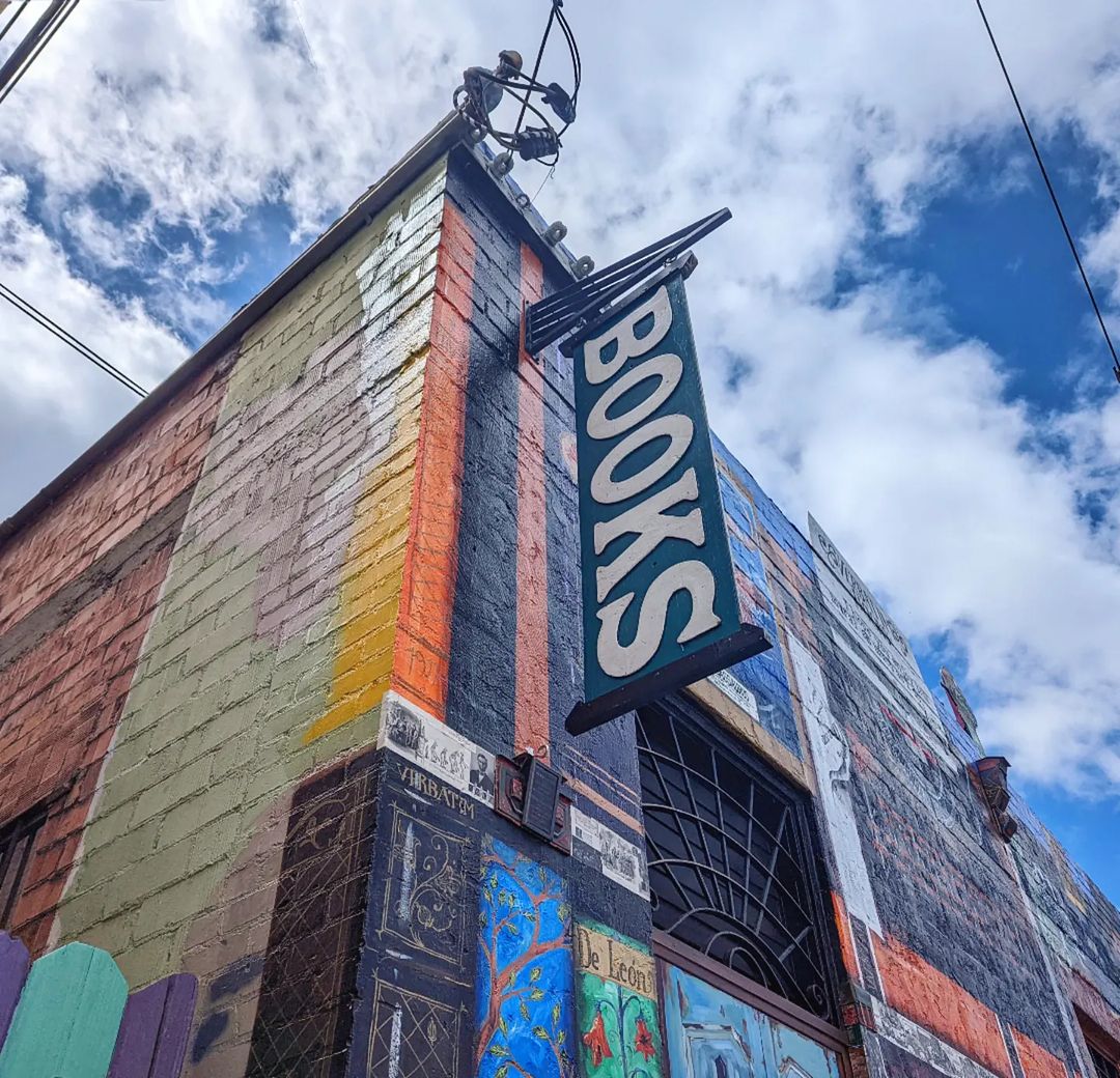 The exterior of Verbatim Books with a banner hanging down that reads: BOOKS