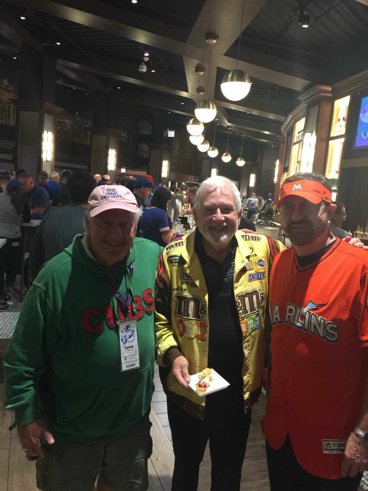 Man in pink best sale hat at cubs games