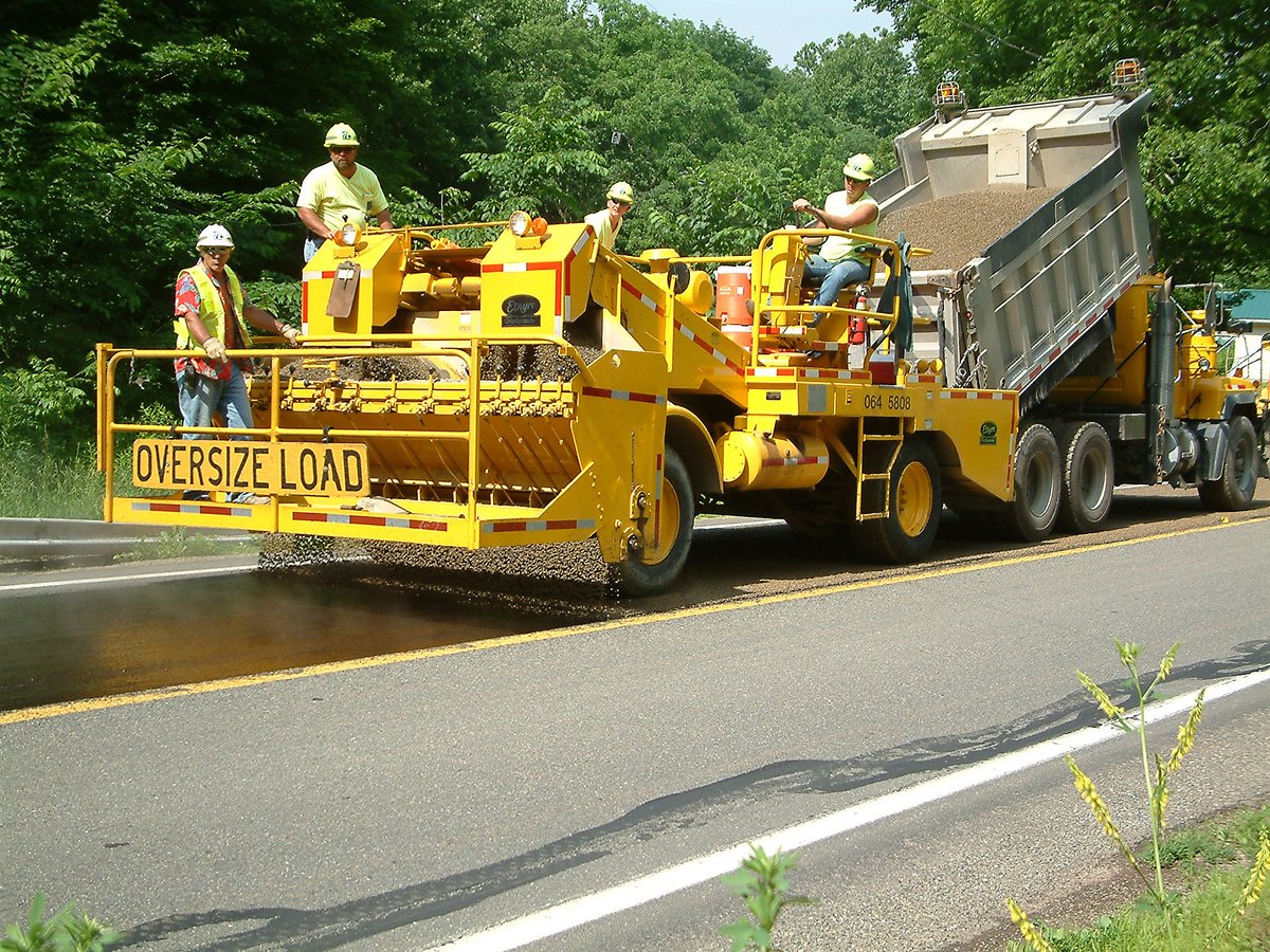 PennDOTNews's tweet photo. "Oil and chip" extends the life of low-traffic-volume roads for another 3-5 years. It takes about two days for the stones to fully bond in the hardened asphalt, so reduce your speed for safety. 

Learn more about our maintenance activities: https://t.co/V8nQNtHcBJ https://t.co/N8CmEqM0cb