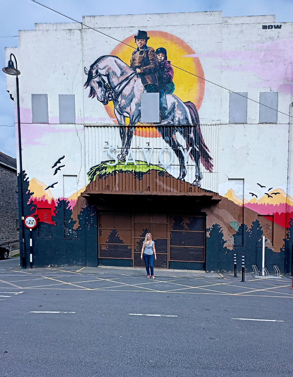 INTO THE WEST....

Déirdre on a mission, stopping off at The Savoy!

The old cinema is draped with a mural inspired by the film ‘Into the West’ (1992) created by artist ADW.
Scenes for the film were shot here.

#keepdiscovering