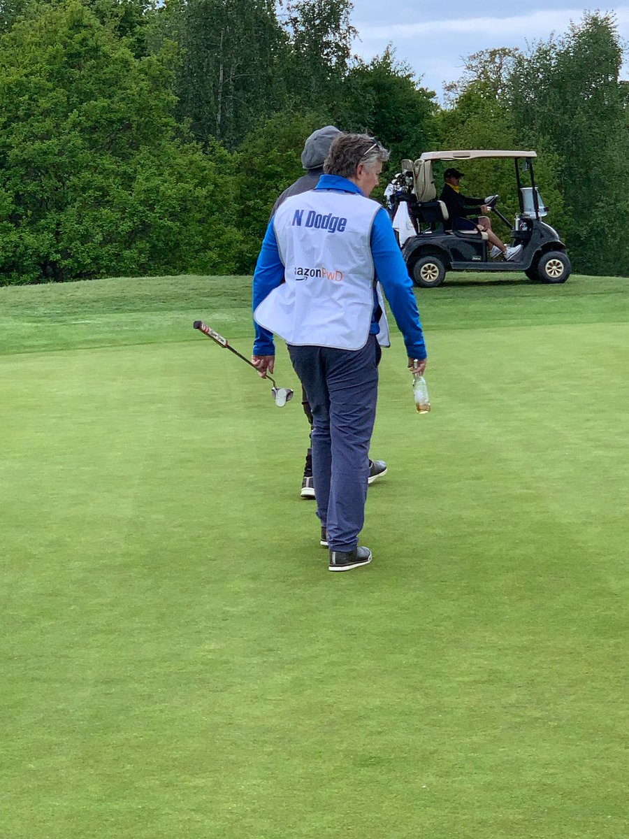 jonathan_favell's tweet photo. What a privilege to caddy for this legend today at The Cairns Cup at ⁦@theshirelondon⁩ Inspirational event with the participants more so.  I’m not sure my caddying style will catch on, but I felt it important to stay hydrated.  ⁦@DodgeNicholas⁩ ⁦@craigcowper⁩ https://t.co/EkcS4QOK78