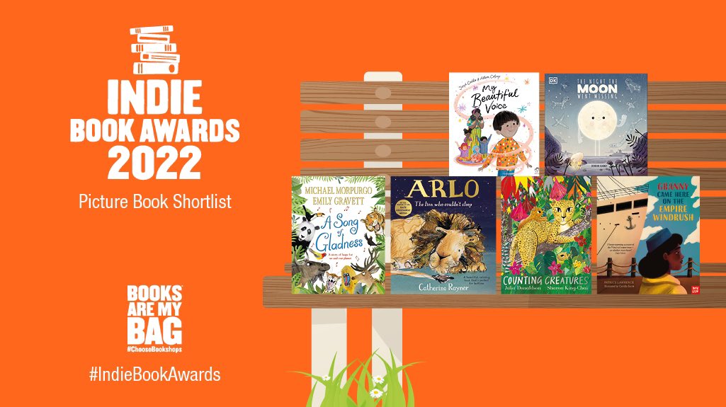 An orange graphic promoting the Picture Book Shortlist for the Indie Book Awards 2022. The logo has five stacked books and the text “Indie Book Awards 2022”. There is a bench with six Picture Book jackets and grass and daisies underneath.