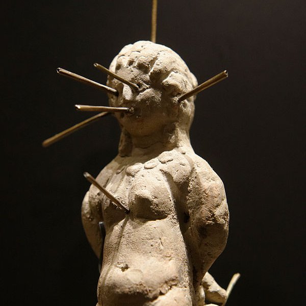 Voodoo doll Louvre (from: https://commons.wikimedia.org/wiki/File:Voodoo_doll_Louvre_E27145b.jpg). Nude female voodoo doll in kneeling position, bound and pierced with thirteen pins. Found in a terracotta vase with a lead tablet bearing a binding spell (katadesmos).