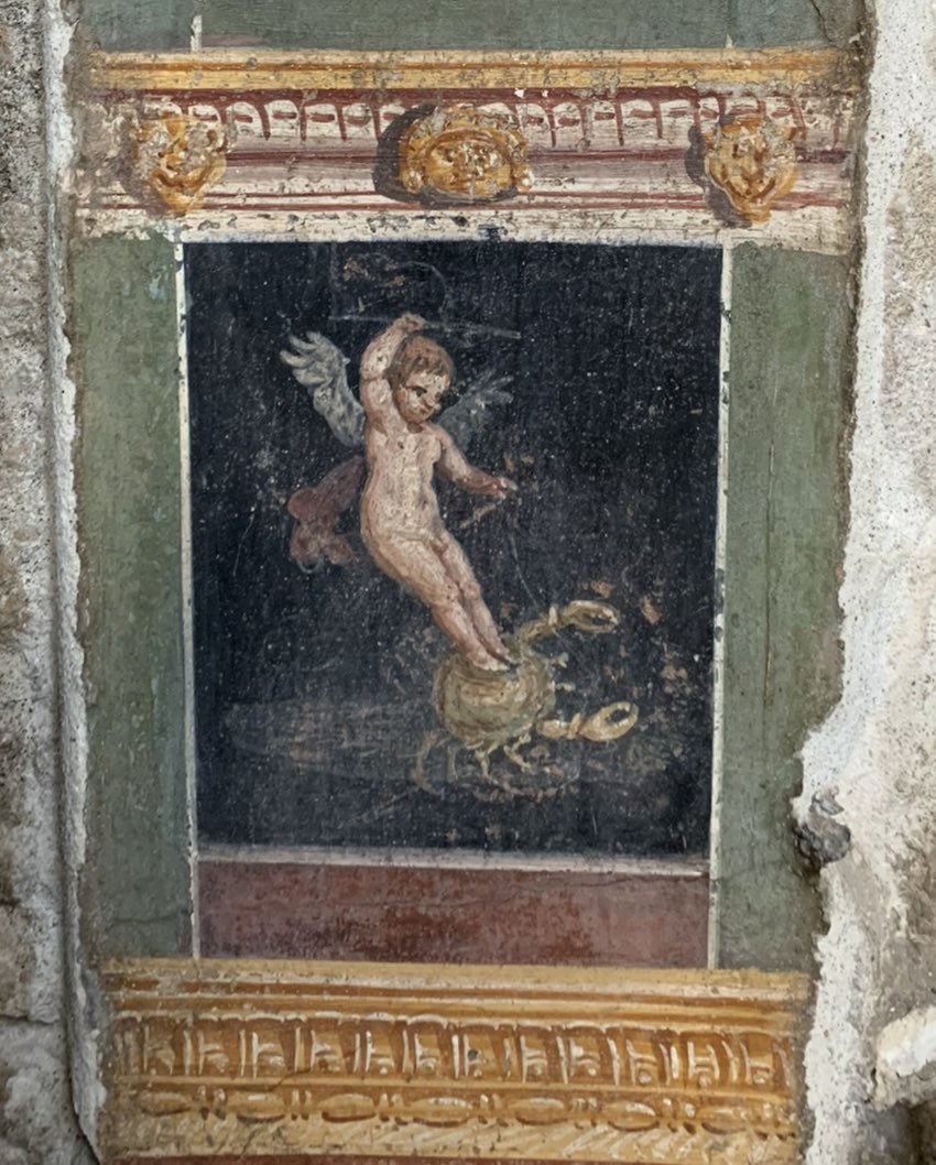 A fresco from Pompeii, showing Cupid riding a harnessed crab.