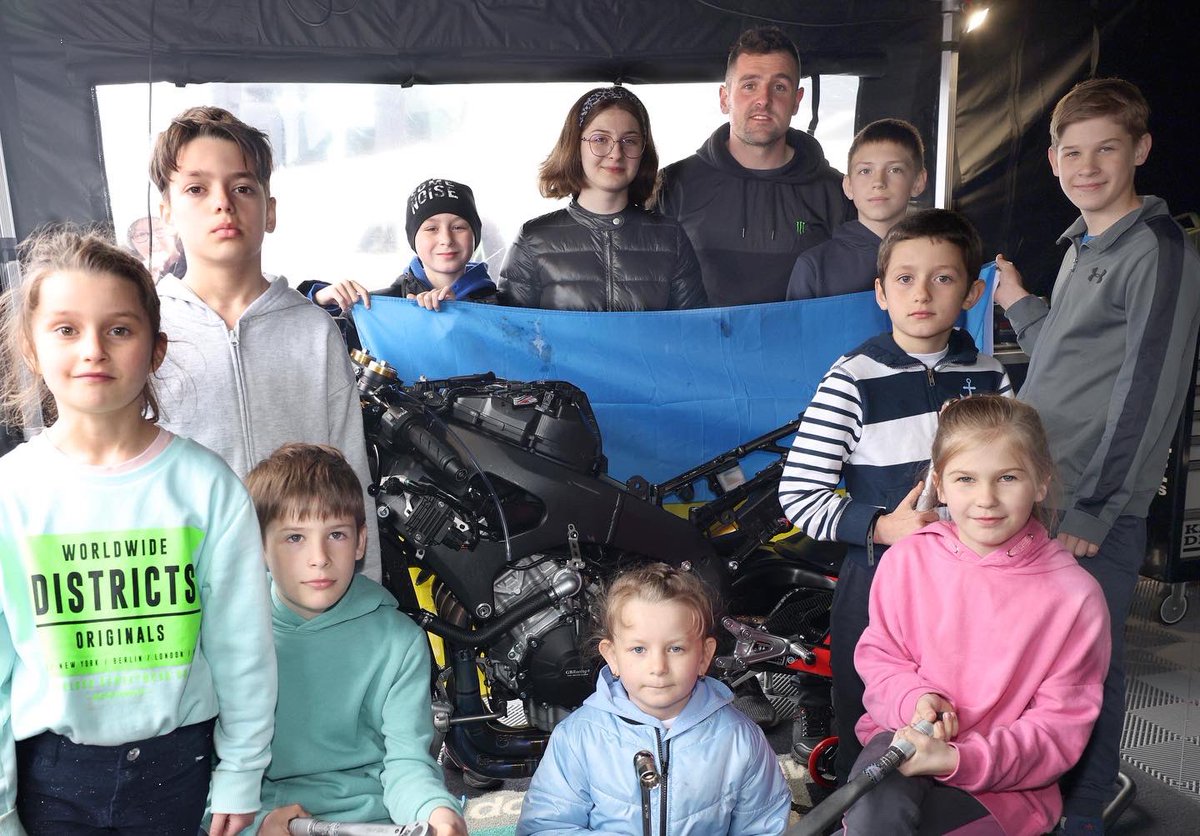 northwest200's tweet photo. A group of 32 Ukranian refugees visited the @fonacabbelfast &amp; @NichollOils NW200 today &amp; met race boss Mervyn Whyte and Councillors from @VisitCauseway before touring the paddock. The Ukranian families have been evacuated by the Faith in Action Missions charity to B’money https://t.co/cM2P9BmkKH