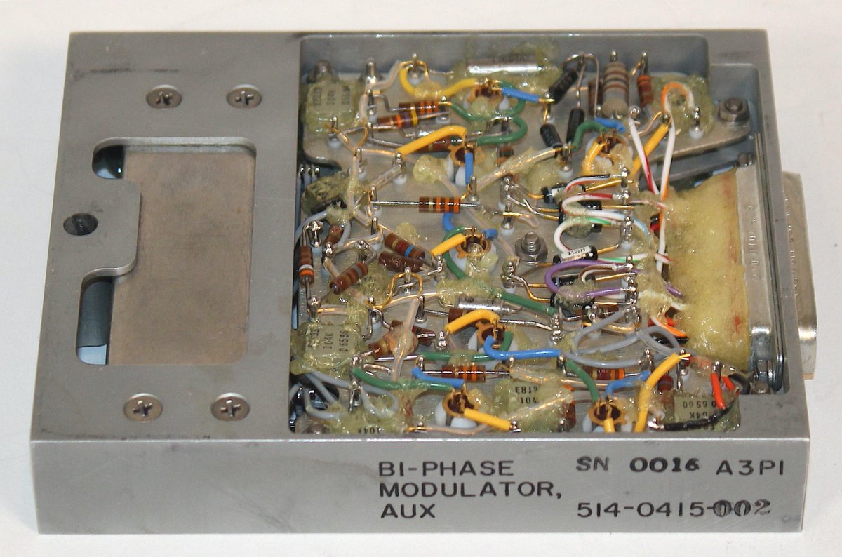 kenshirriff's tweet image. Next, the bi-phase modulator modules encoded digital telemetry data for transmission to ground. Sine waves, normal or inverted, indicate 0 or 1 bits. (I.e. two different phases). For redundancy, there were two modulator modules. The metal box is a 1.024 MHz bandpass filter.