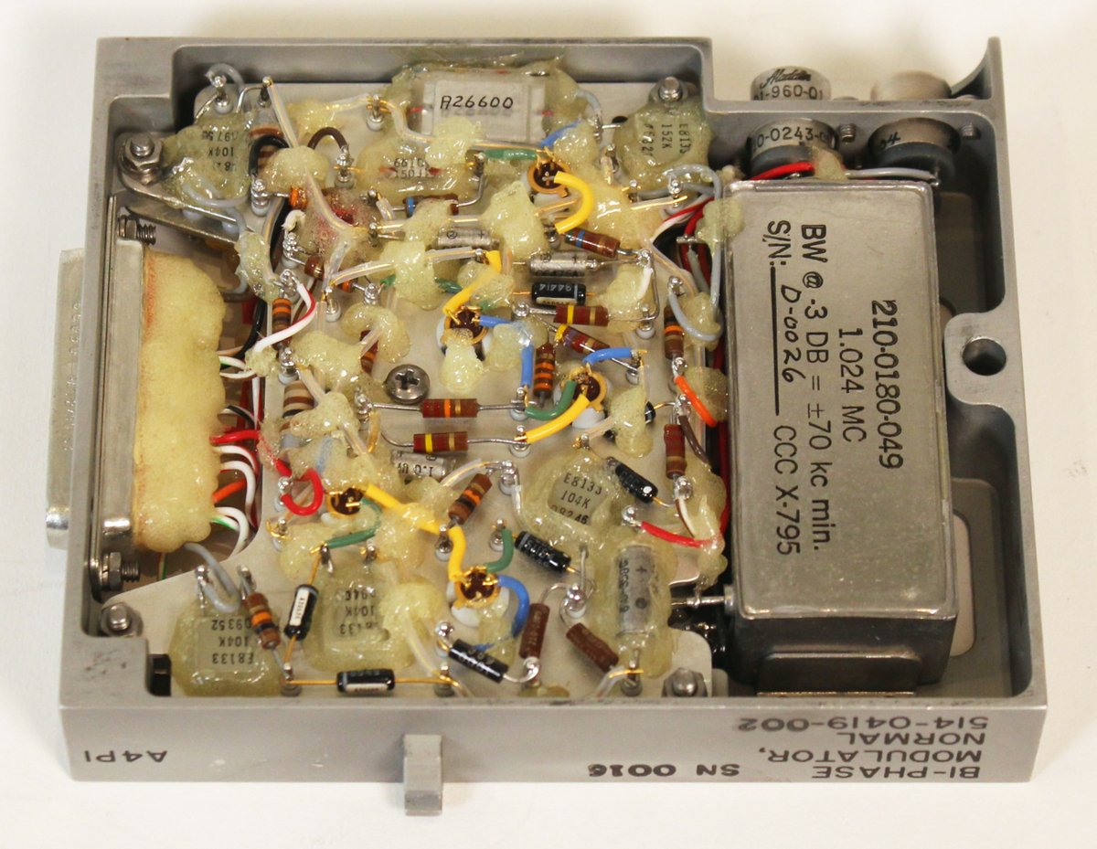 kenshirriff's tweet image. Next, the bi-phase modulator modules encoded digital telemetry data for transmission to ground. Sine waves, normal or inverted, indicate 0 or 1 bits. (I.e. two different phases). For redundancy, there were two modulator modules. The metal box is a 1.024 MHz bandpass filter.