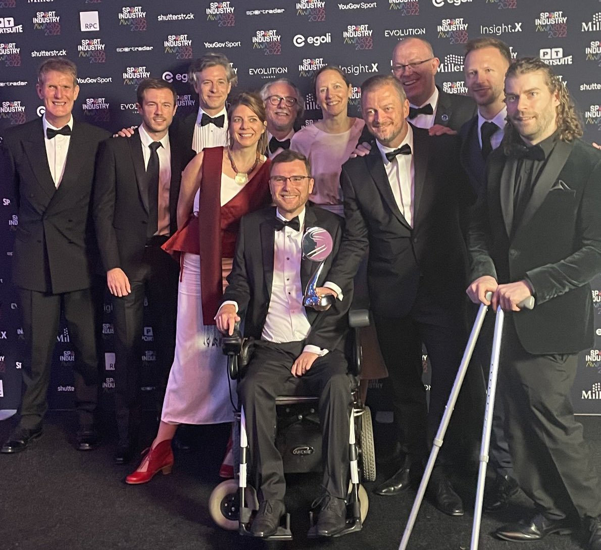 The We the 15 team together at the awards ceremony in London. A group of 11 people smiling for the camera.