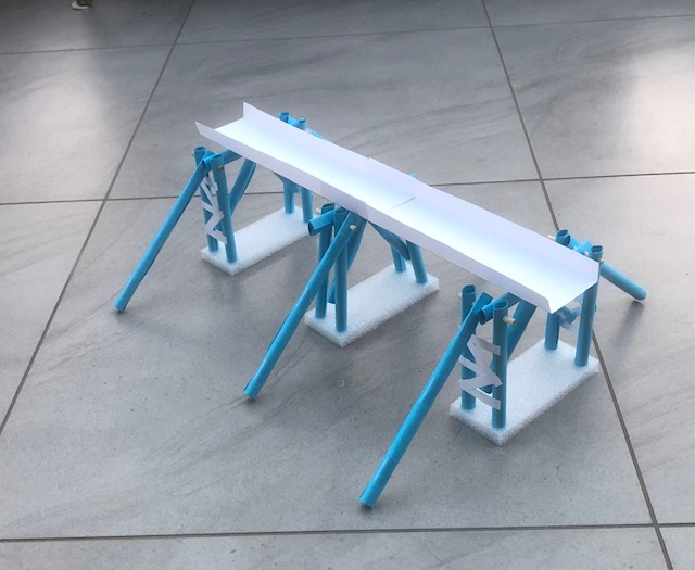 We're used to seeing Roman buildings and structures made from stone but wooden bridges were very common in ancient times and would have been built first then replaced by stone bridges. This is a model wooden Roman bridge with paper tubes and wooden dowels.