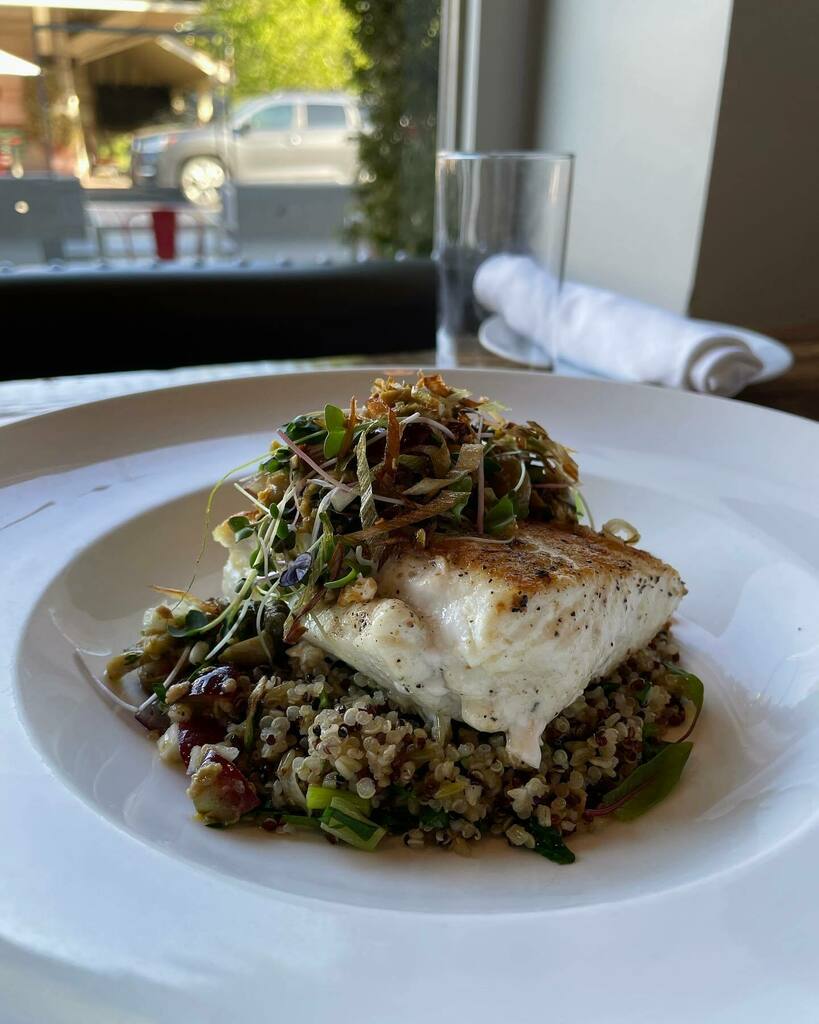 FarmsteadTable's tweet photo. Come on down to Farmstead and taste our new pan-roasted Halibut, served with ancient grains, topped with olive &amp; grape tapenade and crispy leeks. https://t.co/Cc0AH0AJxL https://t.co/VH5h27Dj45