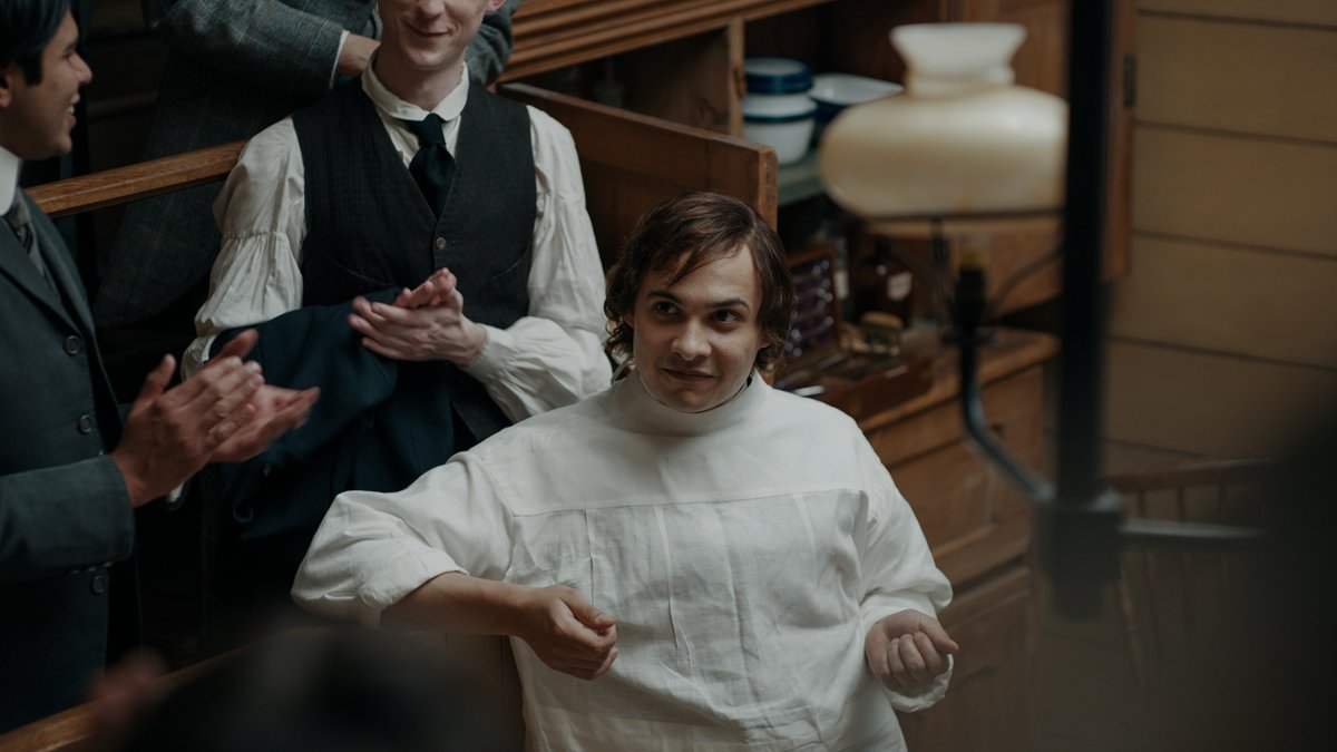 Luke Garrett (Frank Dillane) in The Essex Serpent prepares for surgery in the operating theater, dressed in medical clothing.