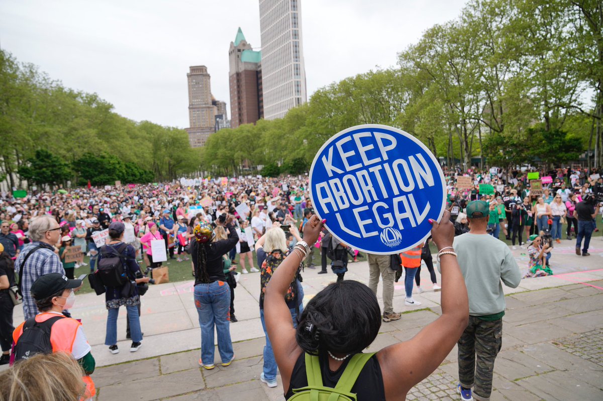 Protesters in Brooklyn. A woman holds a blue sign with white letters reading “Keep Abortion Legal”