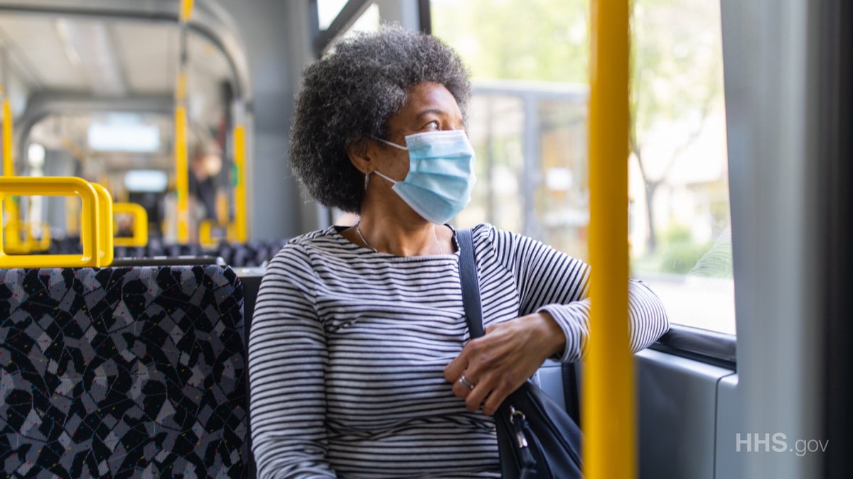 Woman wearing a mask on public transportation.
