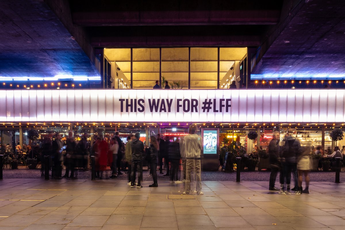 People in front of a cinema marquee with message 'This way for LFF'