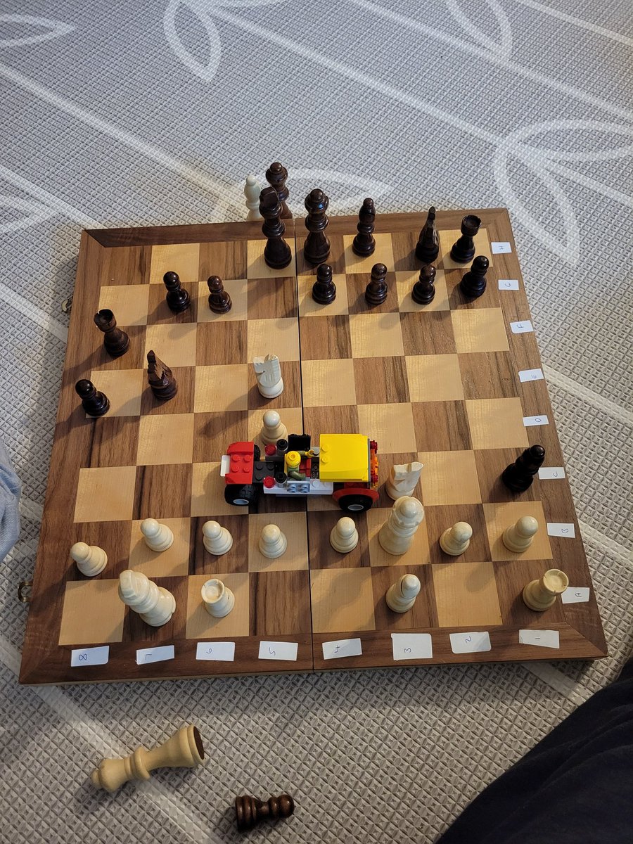 RoryMackin4's tweet photo. So many things wrong with this chess game, the lego truck that just took my bishop is the least of them. Playing with a five year old is trickier than you'd think... https://t.co/AHE5IfwqNH