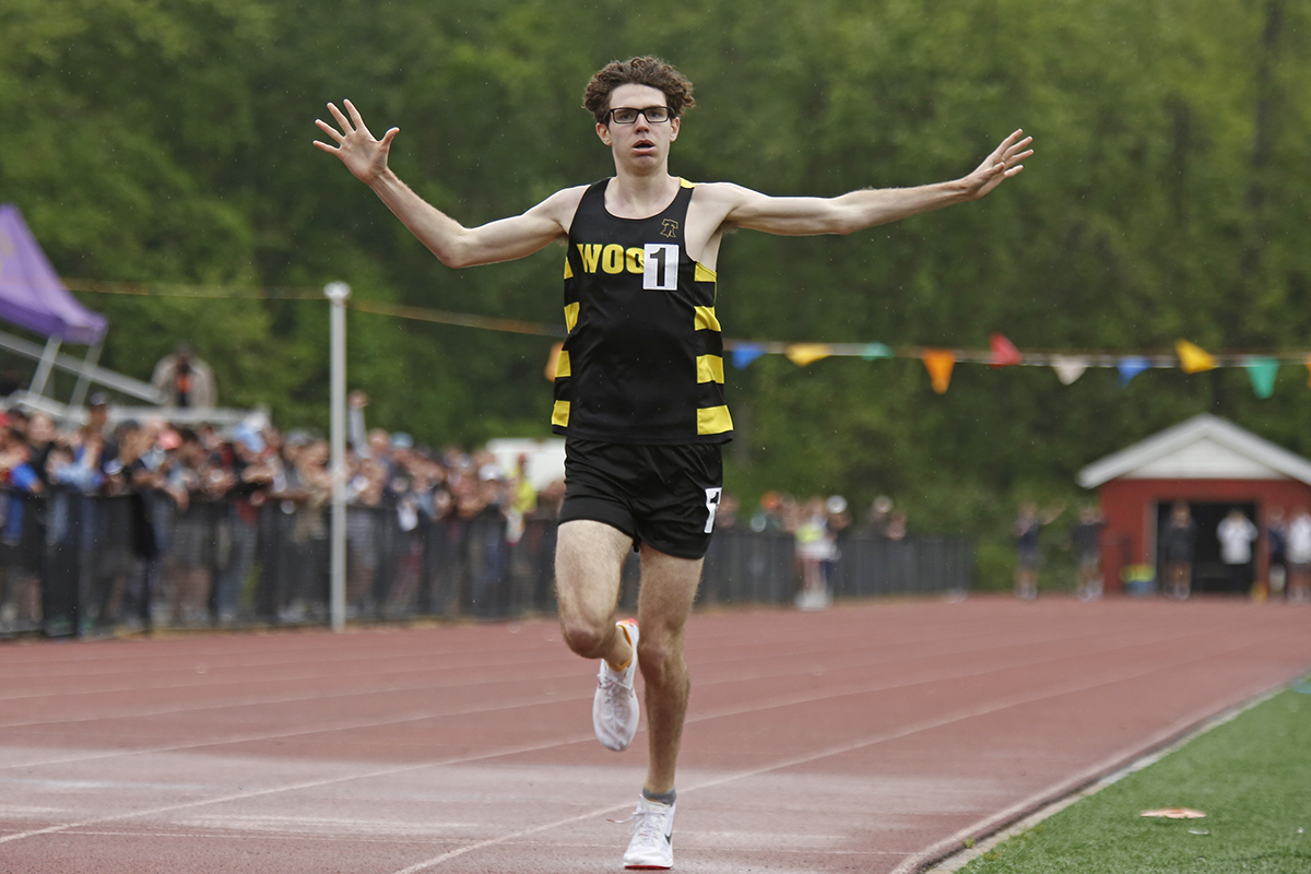 Archbishop Wood’s Gary Martin celebrates after crossing the finish line and becoming the first Pa. high school athlete ever to run a sub-four-minute mile. He ran the mile in 3:57.98 today at the Catholic League championships.