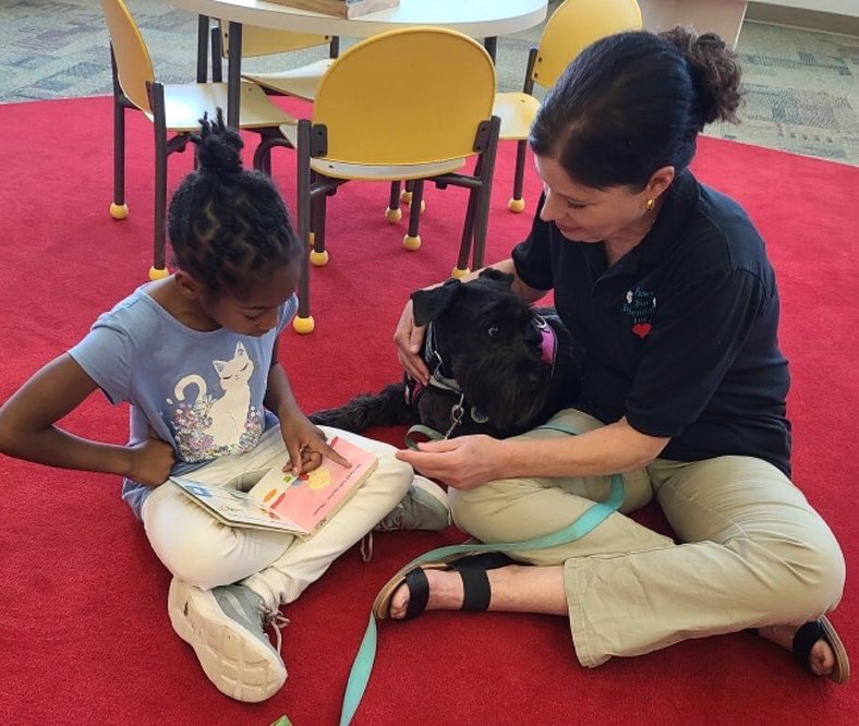 Liberty_STEAM's tweet photo. Read, baby, read! Several of our scholars enjoyed the opportunity to read to the therapy dogs yesterday at the Sumter County Library. Thank you for the invitation! #LibertyForAll #CharterChoiceChange https://t.co/9l3IvmUKlx