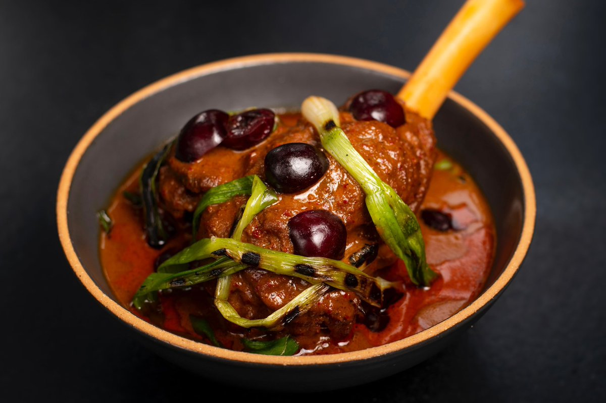 Ripe, juicy cherries and grilled baby scallions top the late Spring version of our gaeng massaman gae. This tender lamb shank falls off the bone in the silky massaman curry and the bright pop of sweetness from the stone fruit adds a lovely contrasting flavor.