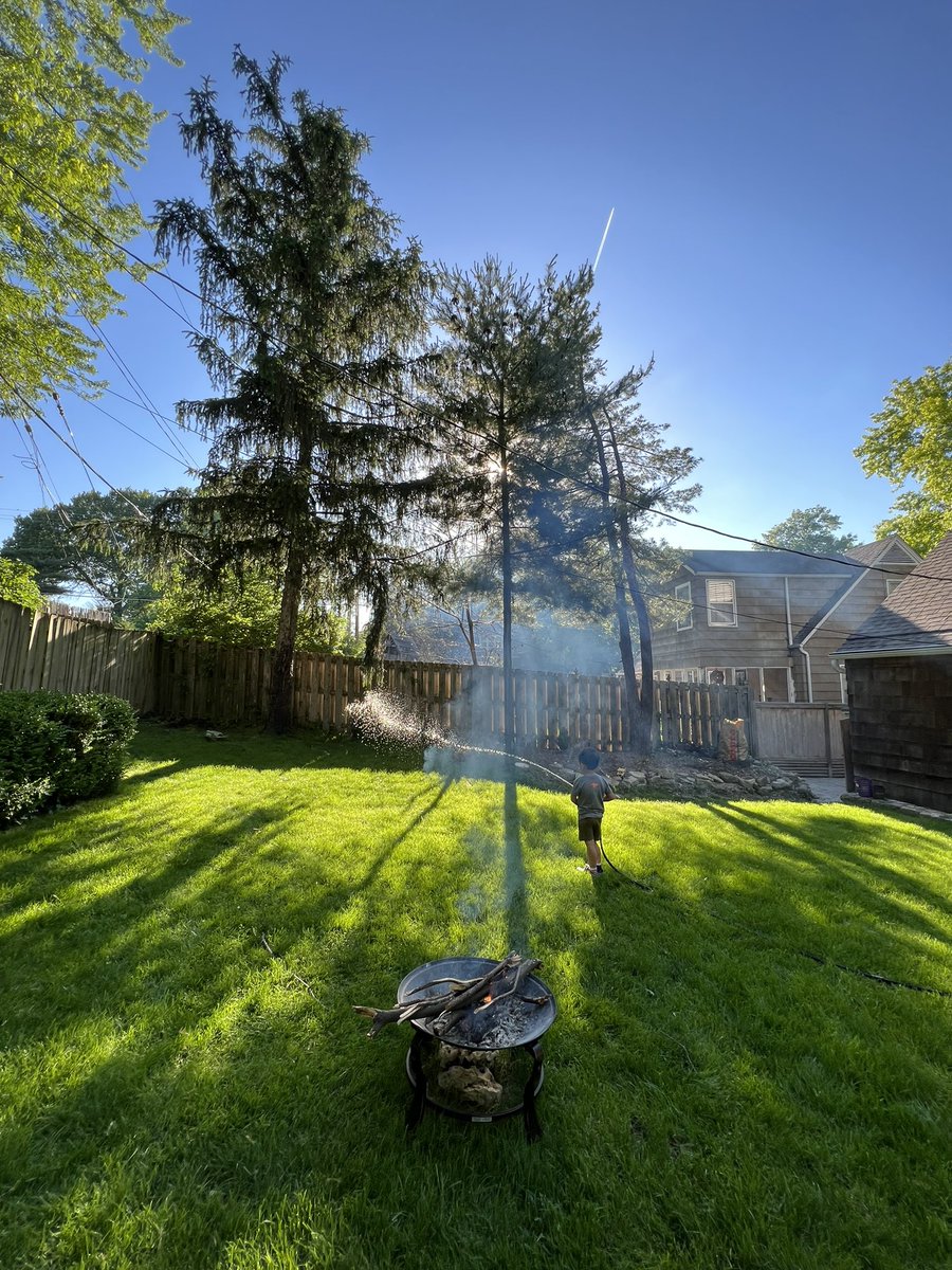 Really dig this photo of son shooting smoke with water from backyard fire pit yesterday evening #summer
