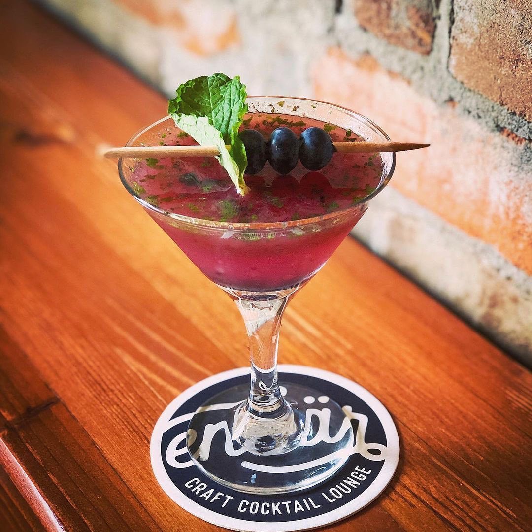The Juniper - our signature cocktail and house favorite. Montgomery Distillery’s Whyte Laydie Gin, fresh blueberries, house-made mint simple syrup &amp; lime juice. Order one next time you are downtown.