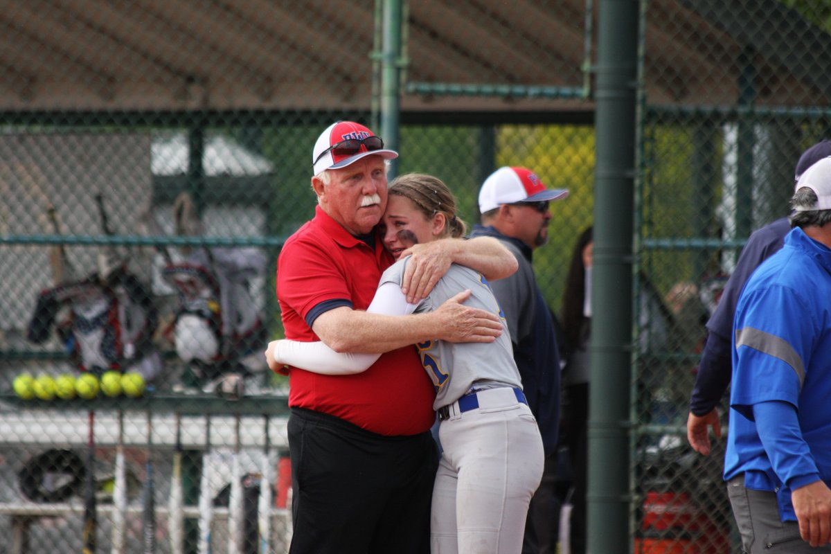 chronline's tweet photo. Pe Ell-Willapa Valley coach Ken Olson comforts his granddaughter Danika Hallom, who plays centerfield for Adna, after PWV defeated Adna for the title. Olson recently announced this would be his final season after a long and successful coaching career.

Photo by Sarah Burdick. https://t.co/ojvqwS218k