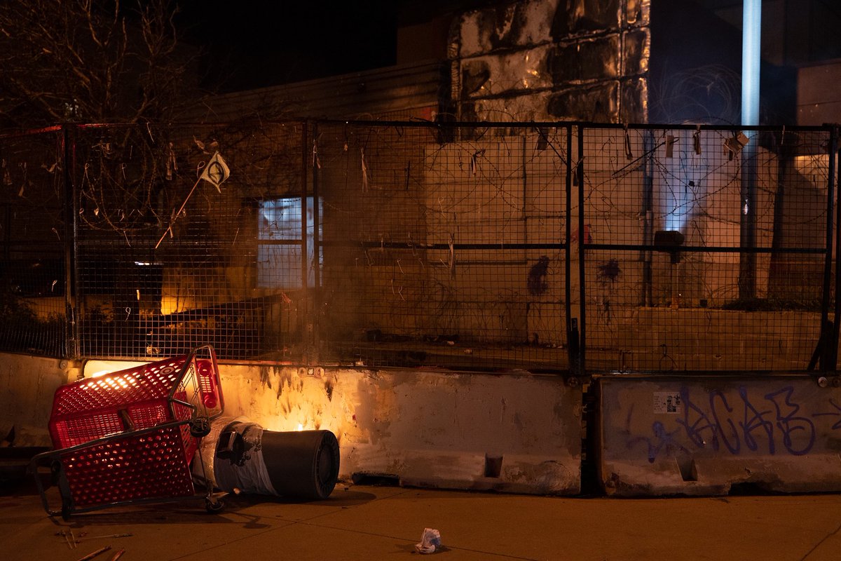 daviss's tweet photo. Protesters marched with a banner reading “Remember May 28th” to the third precinct tonight where fireworks were sent up and shopping carts were set on fire before moving on. https://t.co/JCOqaVGNSt