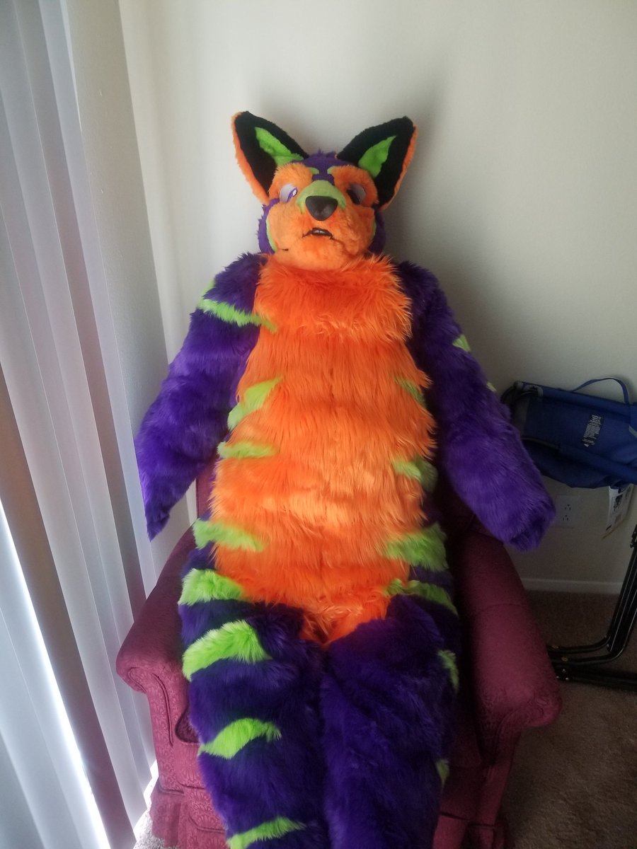 EmeritheC's tweet image. I had a stuffed dtd sitting in this chair, so I thought to put it in a fursuit to add something interesting and less gray to the room.