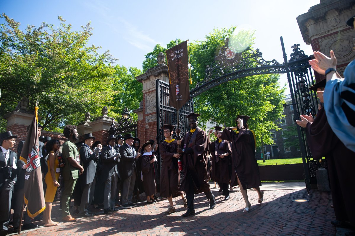 BrownUniversity's tweet photo. #Brown2022 steps through the Van Wickle Gates, cheered on by thousands of alumni, faculty and friends, during Sunday morning’s Procession — a University tradition preceding the College, Graduate School, Medical School and University Commencement ceremonies. https://t.co/D8Lwqq52tp