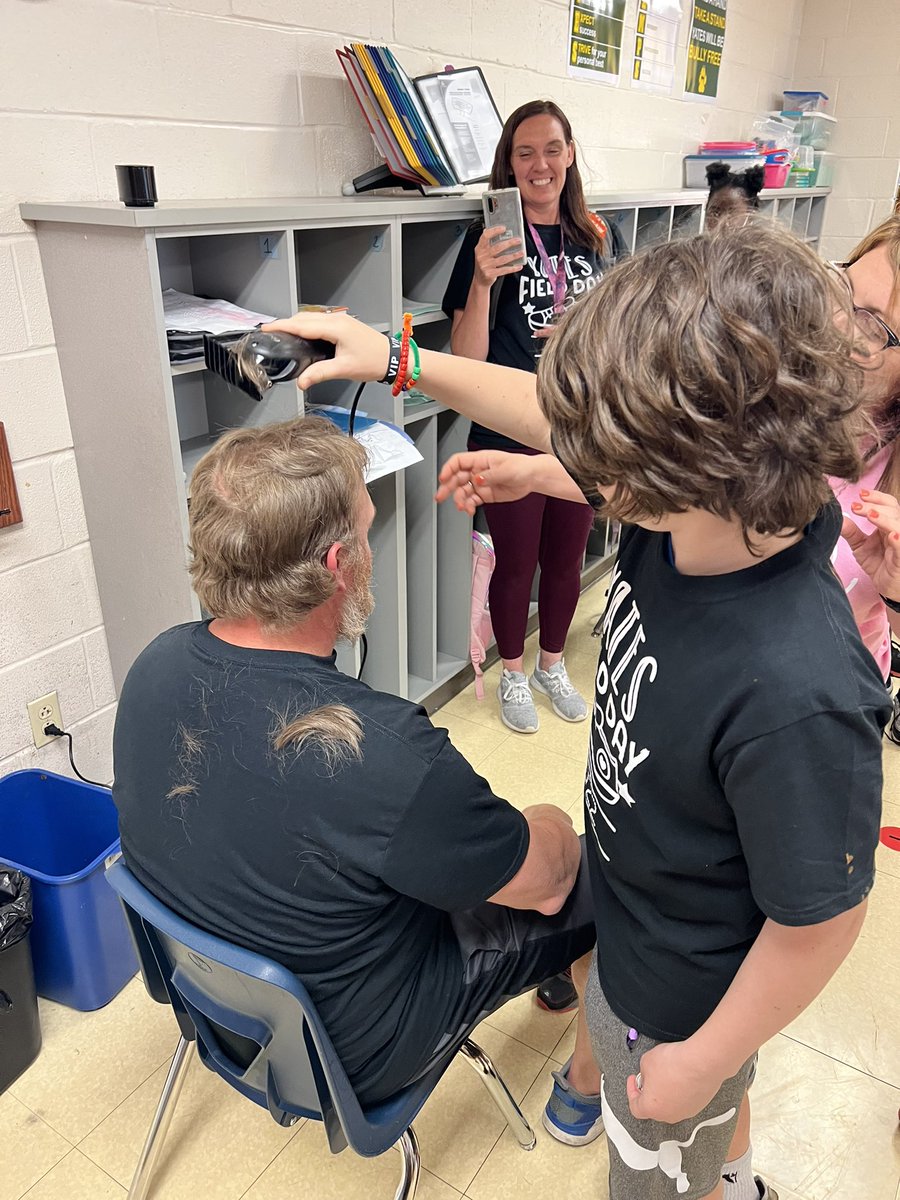BRichburg78's tweet photo. When the class wins the challenge, the PE teacher gets his head shaved! Such a great way to end an amazing field day 2022💚💛! #TeamYates https://t.co/1S2m3Q6oMe