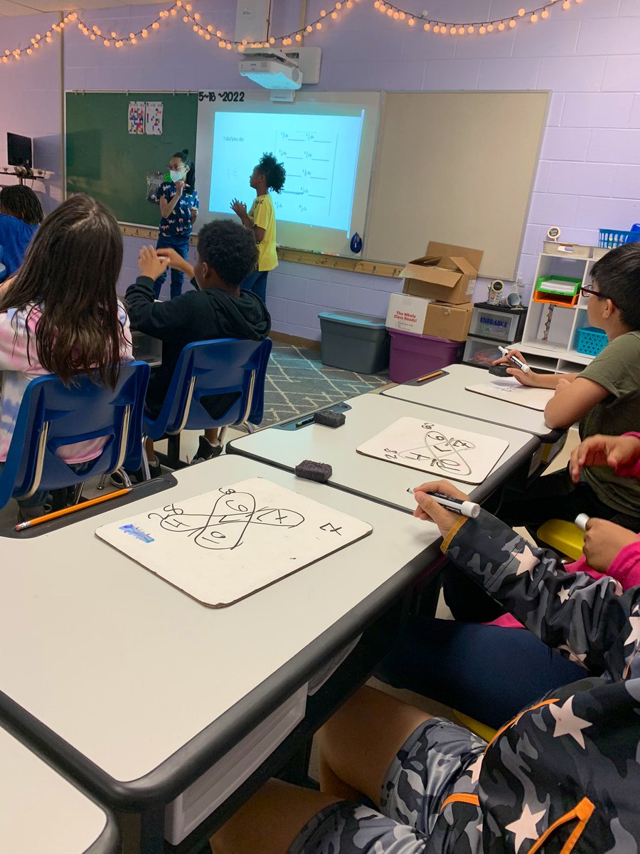 acparker12's tweet photo. Visited Mrs. Endraske’s class this morning as students taught standard based lessons from self-made PPTs on their favorite math concepts learned this year. Great class engagement and creativity 👏💙🧡👏 #TeamDCS @TweetDCS_SIS #Studentled #tellingtime #comparingfractions https://t.co/OSFg5OJlpY