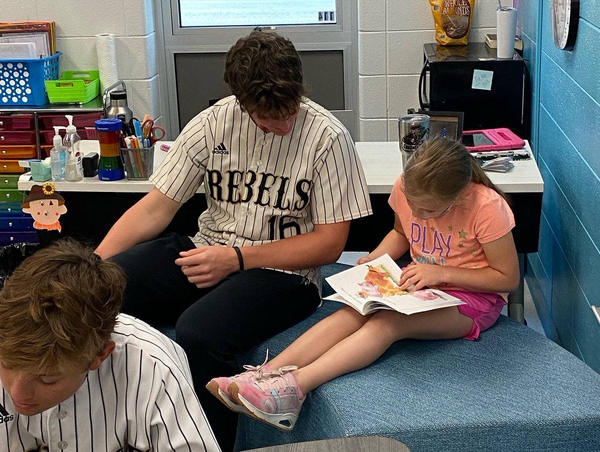 The Rebels enjoyed reading with some of the 2nd grade class this morning. #GoRebels #PracticeReading #StudentAthletes