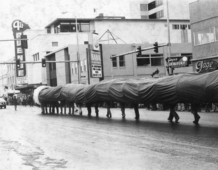 ANC_Historian's tweet photo. 1977, a magnificent ice worm on 4th Avenue in Anchorage during Fur Rendezvous. Per Robert Service, "A Sourdough is a guy who drinks an ice-worm cocktail down." Until then, you're a cheechako. Via Tuzzy Consortium's Tundra Times archive. #alaskahistory #anchoragehistory #iceworm https://t.co/C5SUMyO23B