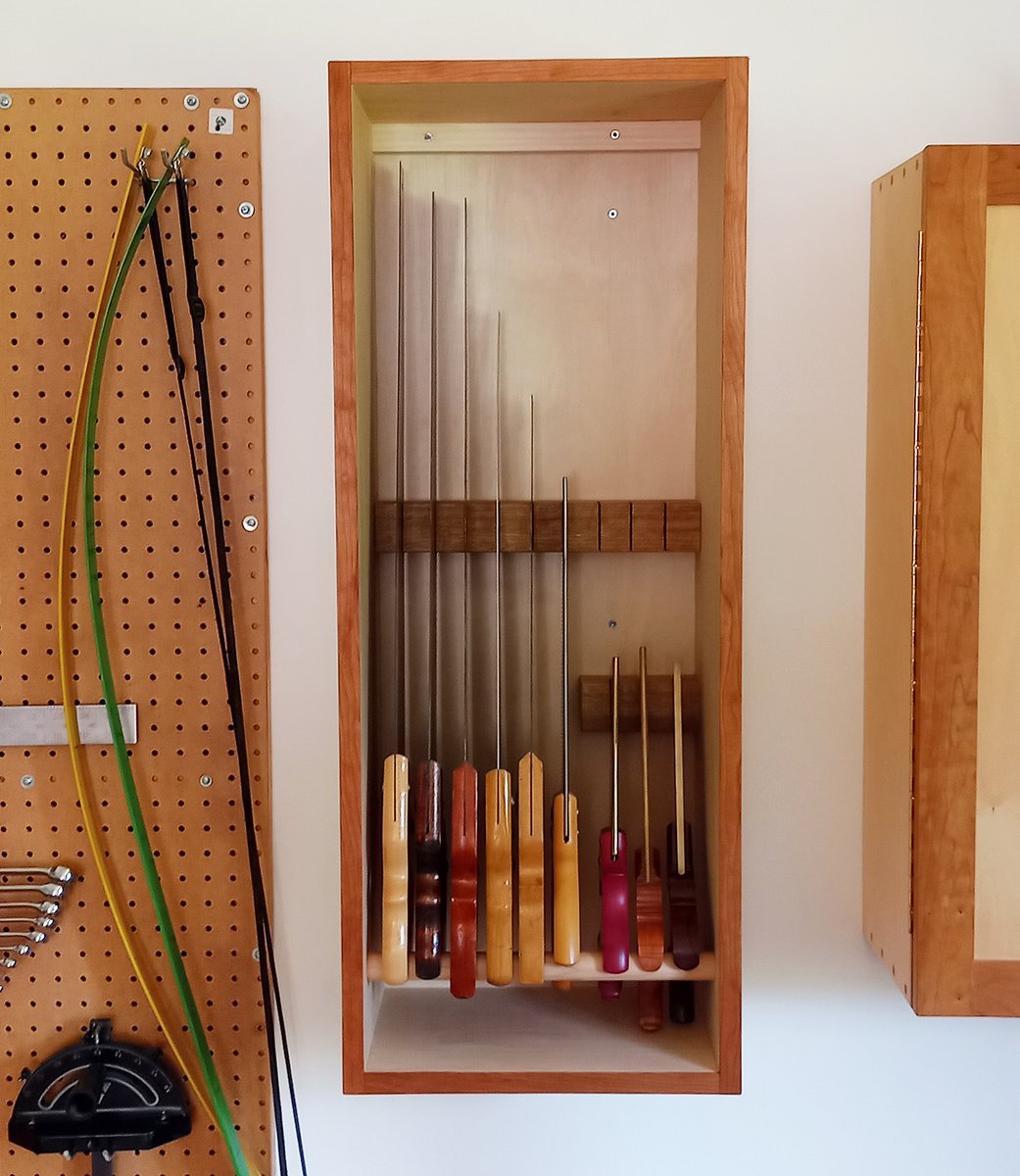 pirollodesign's tweet photo. Wall-mounted saw till installed. Found wall space by rearranging area directly around saw till. 🙂 Also added cherry trim around front edges. #saw #sawtill #toolstorage #woodworkingproject #toolcabinet #handsaws #woodworkingtools #woodworking #finewoodworking #shopstorage https://t.co/1Wx1kP8P6q