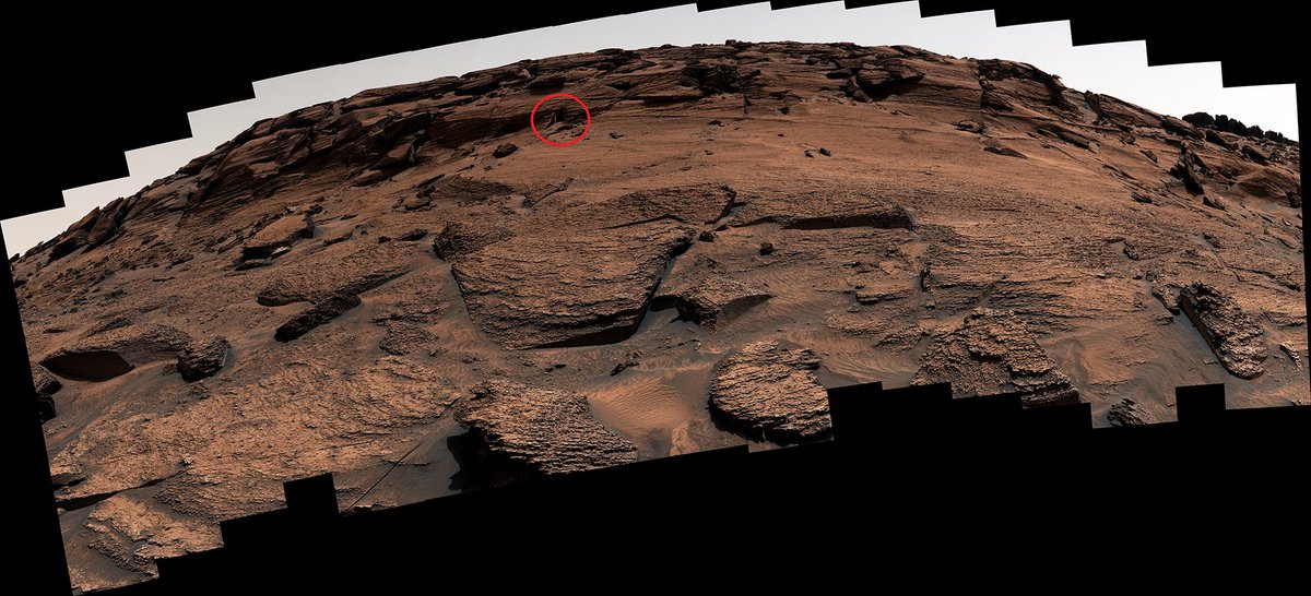 Here’s a zoomed-out view with the feature circled.  In it, you see a small crevice (>30 cm tall) between 2 fractures in a rock. There are several linear fractures in the mound - but in this spot, several fractures intersect, which allowed the rock to break at such sharp angles.