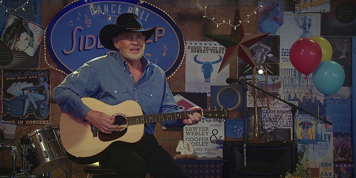 Bonham playing the guitar & singing to his wife at their party