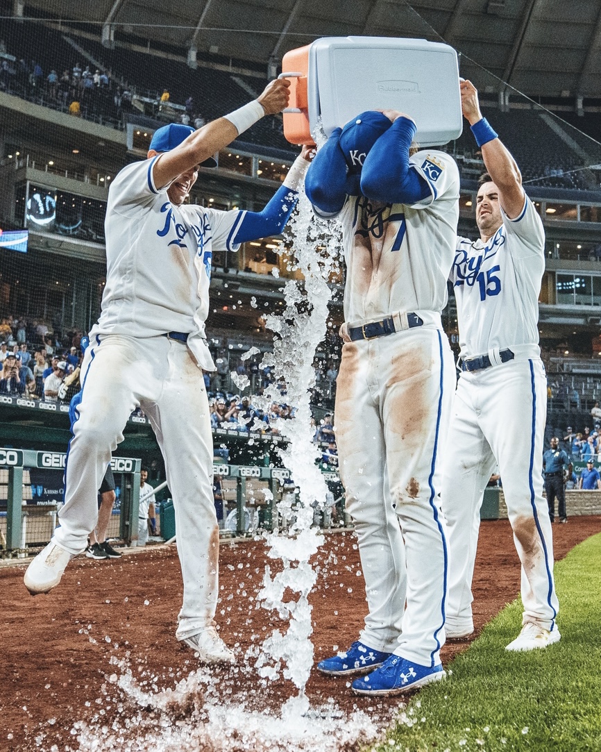 Nicky Lopez and Whit Merrifield splash a mostly-closed cooler of ice water on Bobby Witt Jr. following Wednesday night's win over the White Sox.