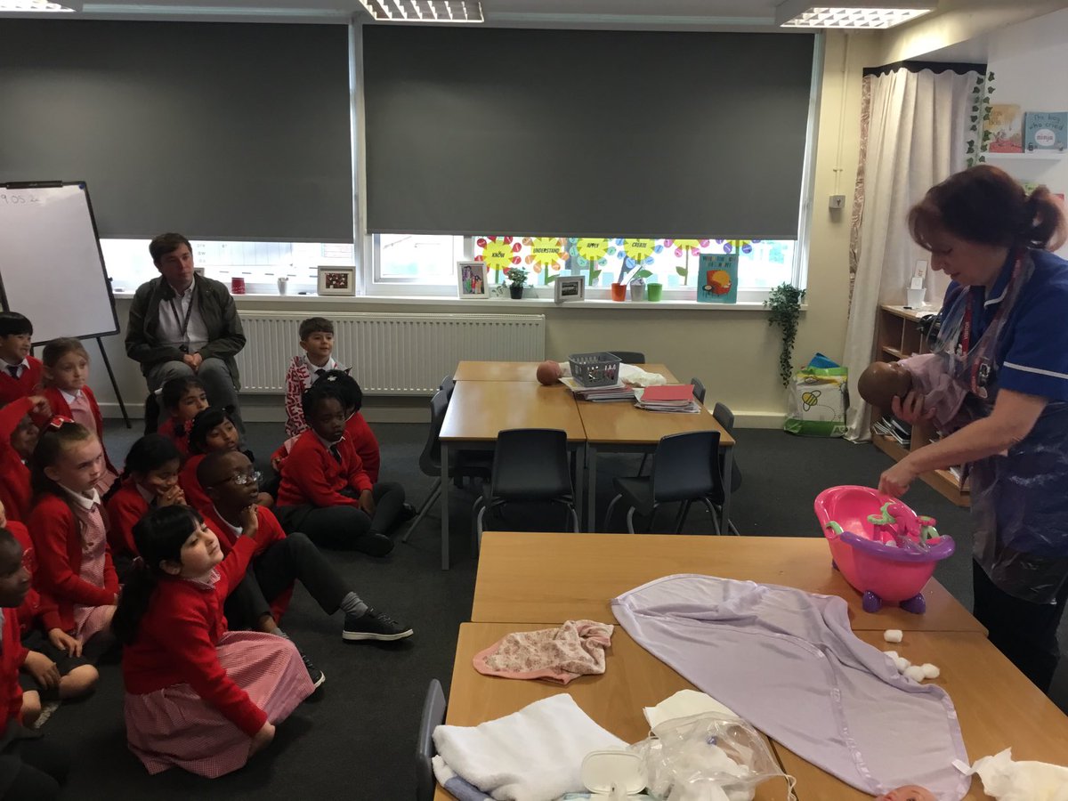 Sacred_heart_Li's tweet photo. As part of our topic People who look after us, year 1 had a visit from a Midwife (Mrs Sim’s Mum)! Irene talked to us about her job and then showed us how to look after a new born baby. #SH7Year1 #SH7Science #SH7PSHE https://t.co/3YM1RS6vMD