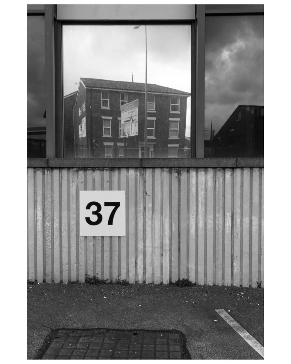 philipgenochio's tweet photo. Office block, #Preston. Another scene that offered more live than I’ve framed here. B&amp;W works a little better with frames within frames but the 37 is too dominant. BT logo is a distraction, neither in nor out of the frame.

#photography #photos #selfcritique #streetphotography https://t.co/u3AQomgBC8