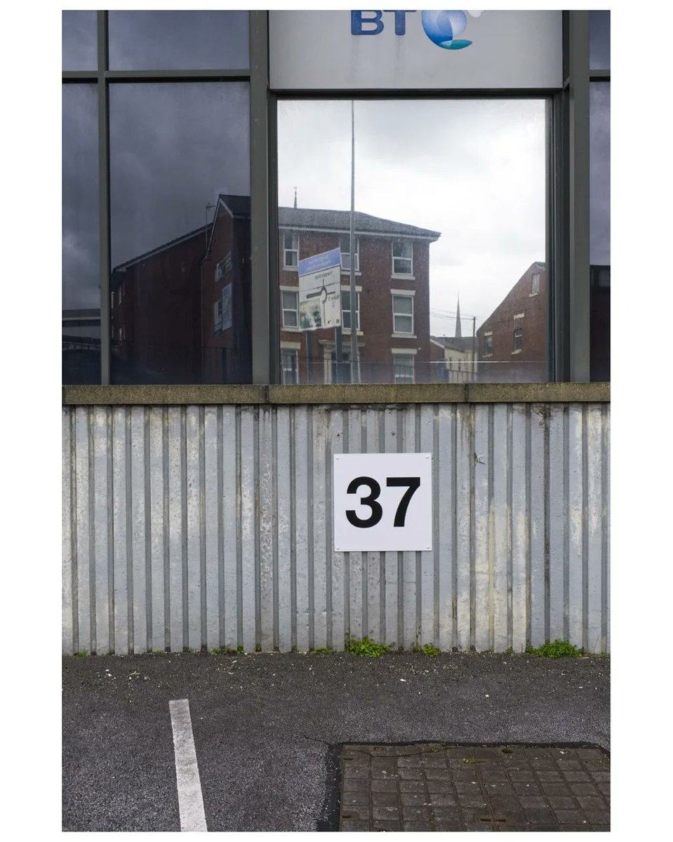 philipgenochio's tweet photo. Office block, #Preston. Another scene that offered more live than I’ve framed here. B&amp;W works a little better with frames within frames but the 37 is too dominant. BT logo is a distraction, neither in nor out of the frame.

#photography #photos #selfcritique #streetphotography https://t.co/u3AQomgBC8