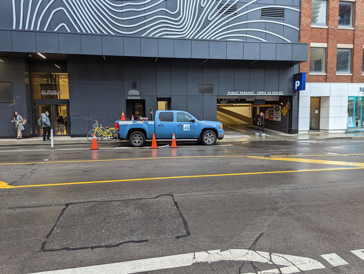 senning's tweet photo. @311Toronto this truck is parked in the bike lane on Peter, just north of King. Ran over the bollard while backing in, for good measure. https://t.co/T0Iq1ftHOZ
