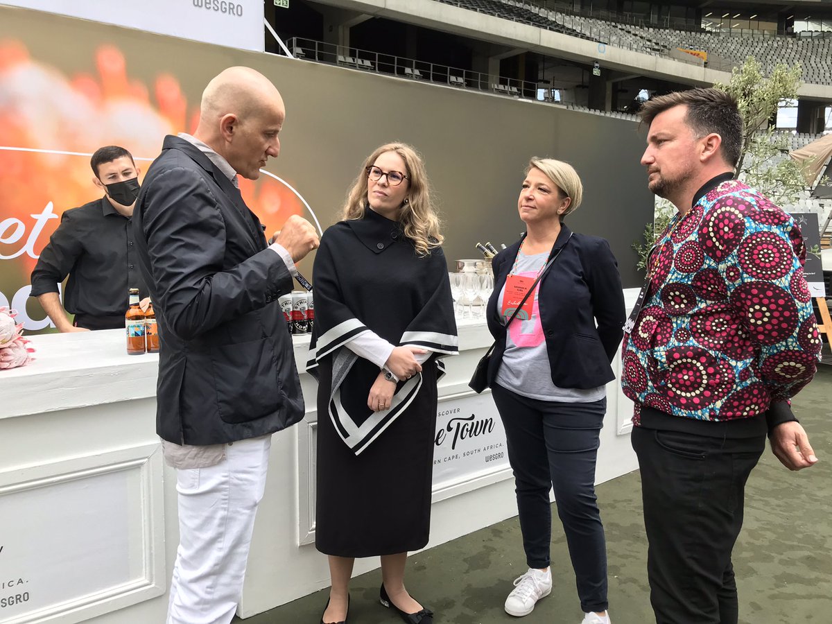 Wesgro's tweet photo. Western Cape Minister of Finance &amp; Economic Opportunities, @MireilleWenger, Wesgro's Chief Destination Marketing Officer, @MonikaIuel with reps from This Is Beyond Group doing a walkabout at the #WeAreAfrica tradeshow @CapeTownStadium to engage with travel brands and buyers. https://t.co/7mN3VnfgnE