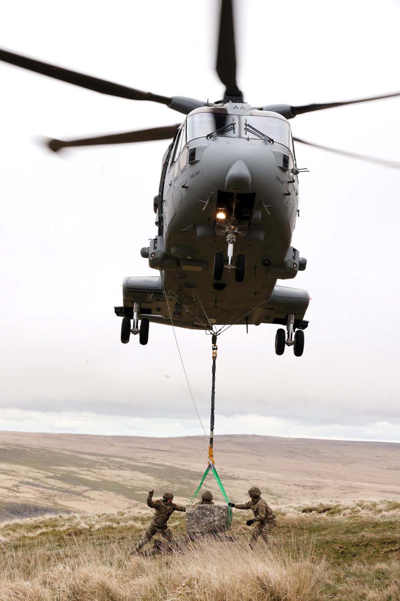 The ground team help manouevre a stone into place