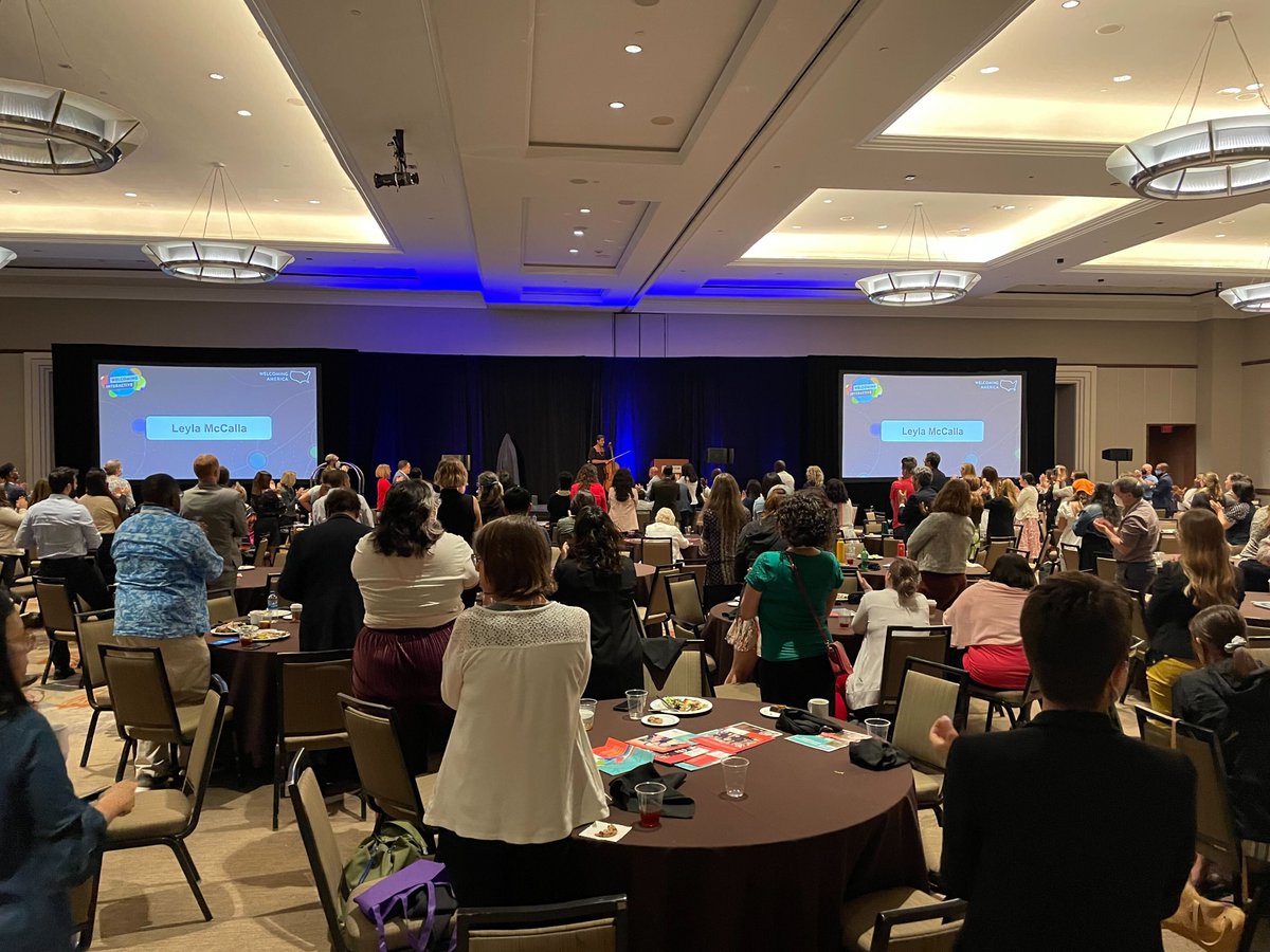 WelcomingUSA's tweet photo. On the recent news of Haitian asylum seekers capsizing near the US coast, @LeylaMcCalla asks: "Why were their temporary protected statuses taken away if the situation hasn't changed?" A standing ovation for her words and performance at #Interactive2022 https://t.co/4BQhhomJSC