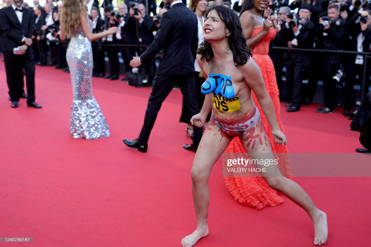 Une activiste SCUM s'introduit sur le tapis rouge du festival de #Cannes2022 pour dénoncer les violences sexuelles infligées aux ukrainiennes dans le contexte de la guerre.

#cannes2022redcarpet