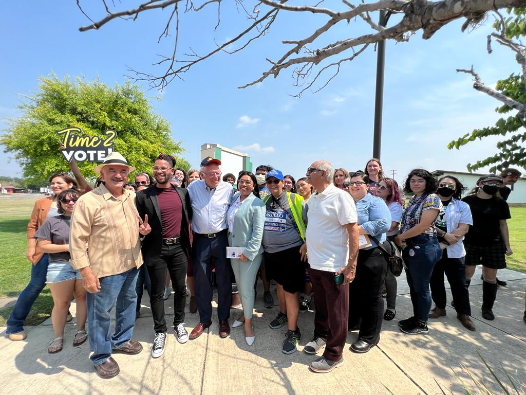 Bernie, Jessica, and supporters standing together, smiling outside
