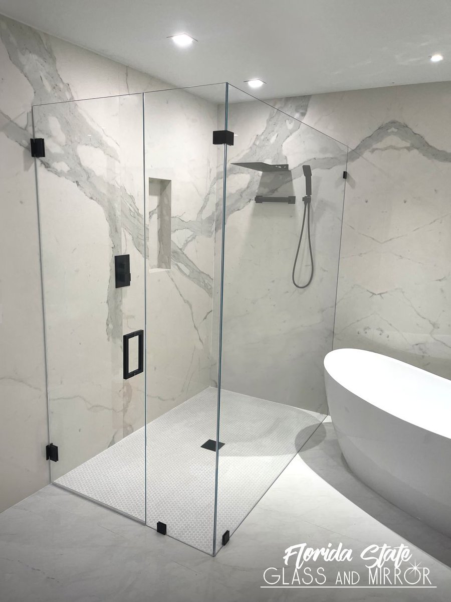 Modern Frameless Shower Doors look fantastic in bathrooms that are of more contemporary design or for those that use simple, sleek lines. Call Us for a Free Estimate at 561-9976990 #framelessshower #blackhardware #shower #showers #showerenclosure #glassexperts #floridastateglass