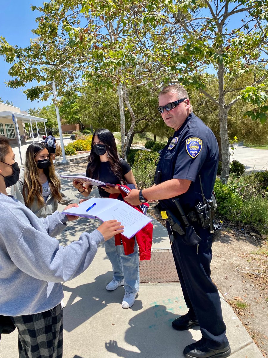 Our awesome SRO Officer Harbin getting to know our students during lunch time and signing yearbooks!